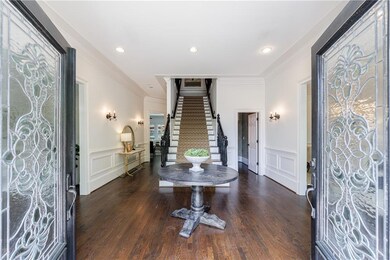 Front foyer entry with Leaded glass French doors and center staircase