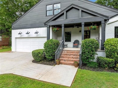 View of front of house featuring covered porch, driveway, and a ceiling fan
