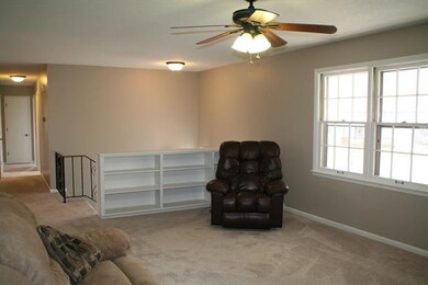 Living room features built in book shelves, new ca