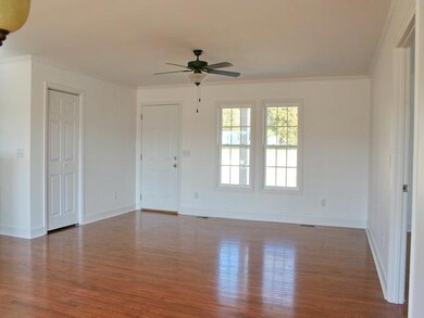 12x16 ft great room with coat closet on the left. Hardwood floors except for baths and utility.
