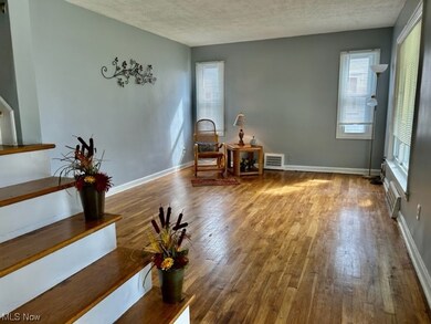 Sitting room featuring hardwood flooring and a textured ceiling