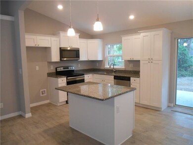 Kitchen with granite counter tops and stainless st
