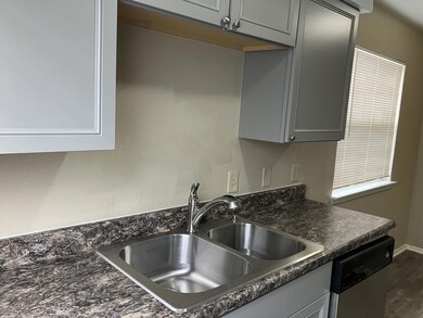 Kitchen featuring stainless steel dishwasher, a s