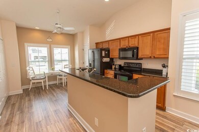 Kitchen with brown cabinets, light wood-style floo