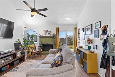 Living room with a textured ceiling, ceiling fan, 