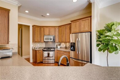 Gourmet kitchen with SS appliances and gas stove.