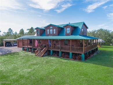 Rear view of property with a carport, covered porc