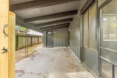 Property entrance featuring a carport and a patio area