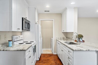 Kitchen with white cabinets, gorgeous countertops,