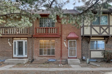 View of front of house featuring brick siding and a shingled roof
