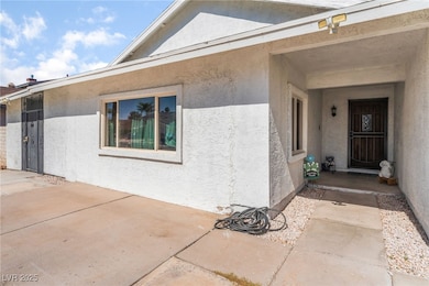Entrance to property featuring stucco siding and a