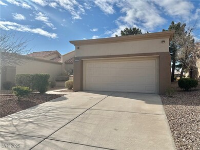 View of front of house with stucco siding, an atta