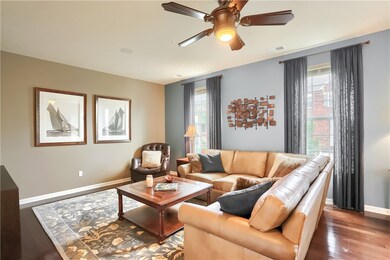 Living room with custom blinds and draperies and h