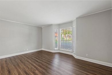 Empty room with dark wood-style floors, baseboard