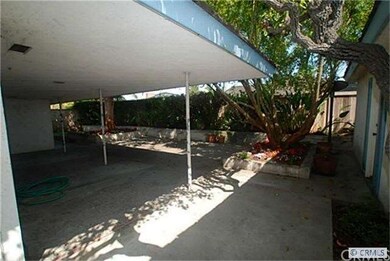 Covered patio in backyard that is under the roof l