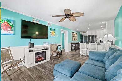 Living room with ornamental molding, ceiling fan, 