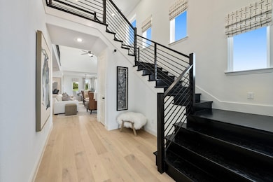 Stairway featuring wood-type flooring and a toweri