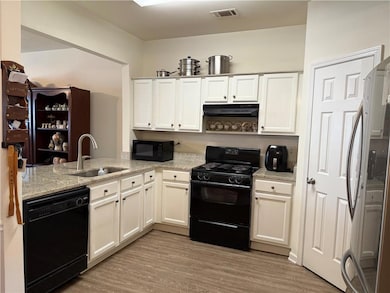 Kitchen with visible vents, a sink, under cabinet 