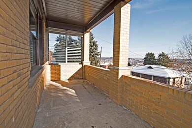 THE LARGE COVERED FRONT PORCH OF THIS WELL BUILT B