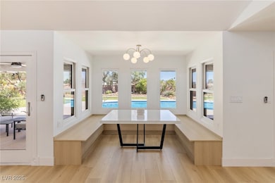 Dining room featuring light wood-type flooring, pl