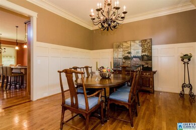 Gorgeous custom molding in this large dining room...perfect spot for holidays and special occasions...your guests will love this home! Plantation shutters across front of home, wood blinds throughout the rest of home.