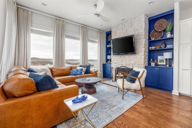 Living room featuring a stone fireplace, a ceiling