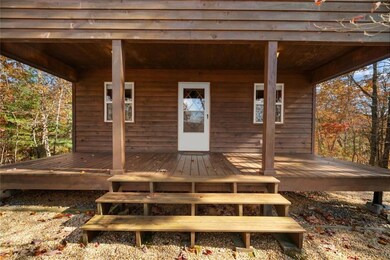 View of exterior entry with a deck