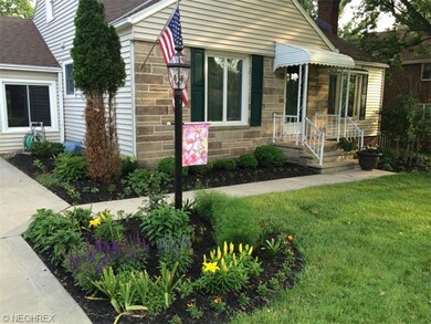 Professional landscaping adorn the front entrance.