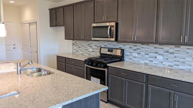 Kitchen with appliances with stainless steel fini