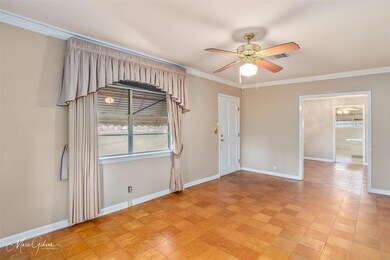 Spare room with crown molding, light parquet floor
