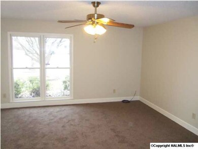 The master bedroom with new carpet, ceiling fan and walk in closet