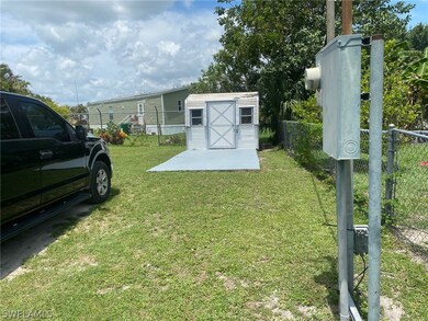 Shed with concrete pad in front.