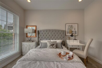 Bedroom with multiple windows and light colored ca