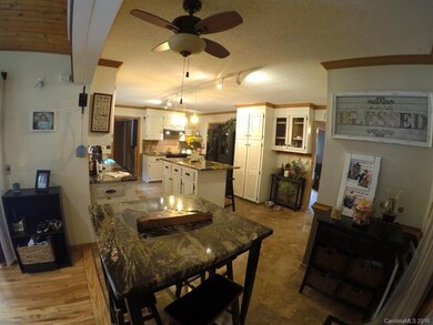 Looking across kitchen from living room toward lau