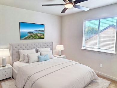 Carpeted bedroom with baseboards and a ceiling fan