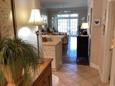Hall featuring crown molding and light tile patter