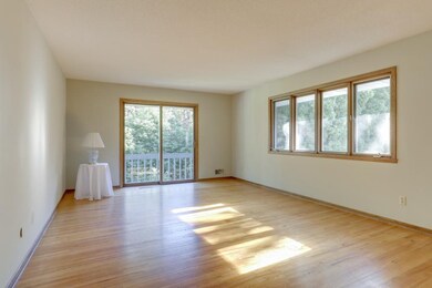 The living room offers hardwood floor, a wall of w