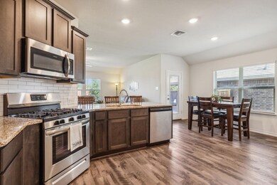 Spacious kitchen with granite counters, stainless steal appliances all open to family room and dinging room. Don't miss huge walk in pantry!