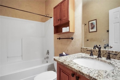 Full bath featuring vanity, toilet, and bathtub / 