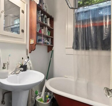 Bathroom featuring a soaking tub and a sink