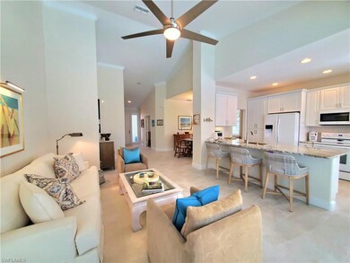 Living room with light tile flooring, ceiling fan,