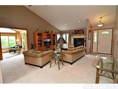 Living Room with vaults, a fireplace and open to k
