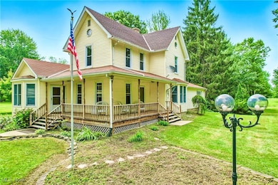 View of front of house featuring a porch, roof with shingles, and a front lawn