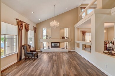 Living area featuring high vaulted ceiling, a chan