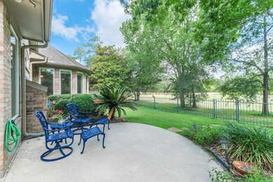 Back patio with tree lined views of golf course.