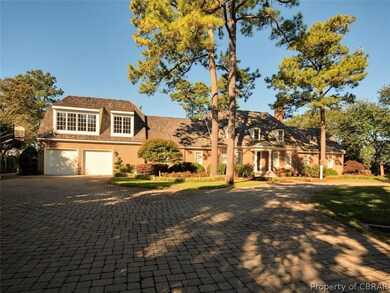 Front view of this Colonial Inspired home with pav