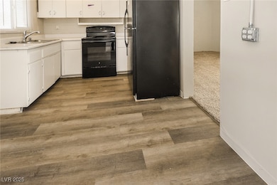 Kitchen featuring light countertops, white cabinet