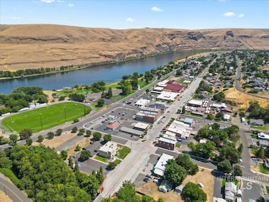 Aerial overview of property's location with a water and mountain view and nearby suburban area