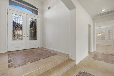 Foyer featuring arched walkways, tile patterned fl