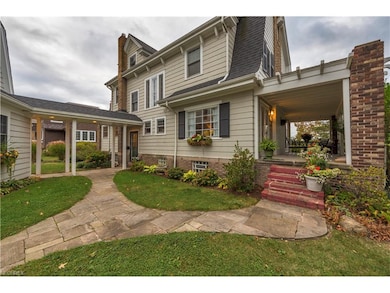 Sandstone paths lead from the driveway to the fantastic side porch.  Owners also designed a covered walkway from the garage to the back door.